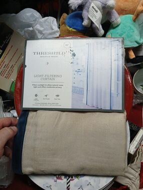 Threshold light-filtering curtain panel features a rod pocket and back tabs